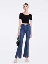 A lady wears a black crop top.